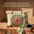 A large canvas tote bag featuring an embroidered geometric mandala circular design on the front panel with a fringed trim along the top rim and leather shoulder handles.