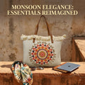 A large canvas tote bag featuring an embroidered geometric mandala circular design on the front panel with a fringed trim along the top rim and leather shoulder handles.