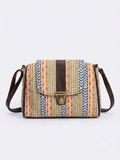 A textured crossbody sling bag featuring a vibrant multicolor front panel, shown open to display two top zipper sections and an adjustable shoulder strap.