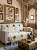 A textured cotton sofa throw featuring a geometric diamond pattern in contrasting mustard yellow and black, detailed with tufted fabric accents and fringed edges.