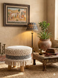 Handcrafted boho woven pouf ottoman used as a floor seating cushion in a living room by Anhad Rang