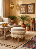 Handcrafted boho woven pouf ottoman used as a floor seating cushion in a living room by Anhad Rang